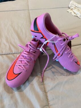 Nike Women's Pink Soccer Cleats with Orange and Black Accents